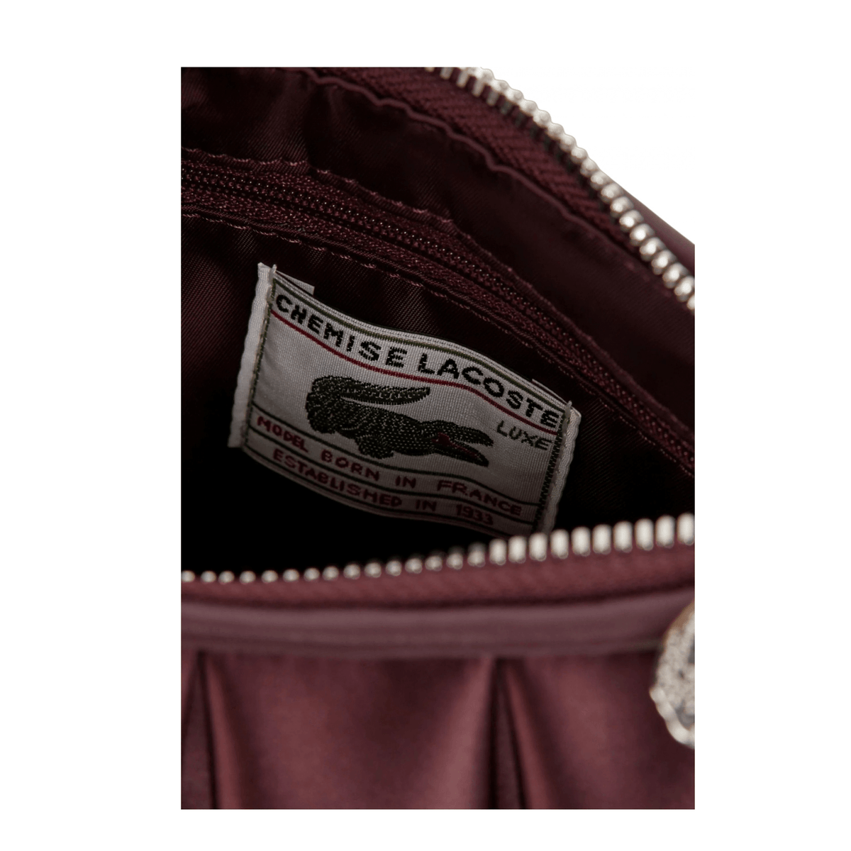 Intérieur du sac Lacoste Lenglen S Oxalis avec étiquette Lacoste et fermeture zippée