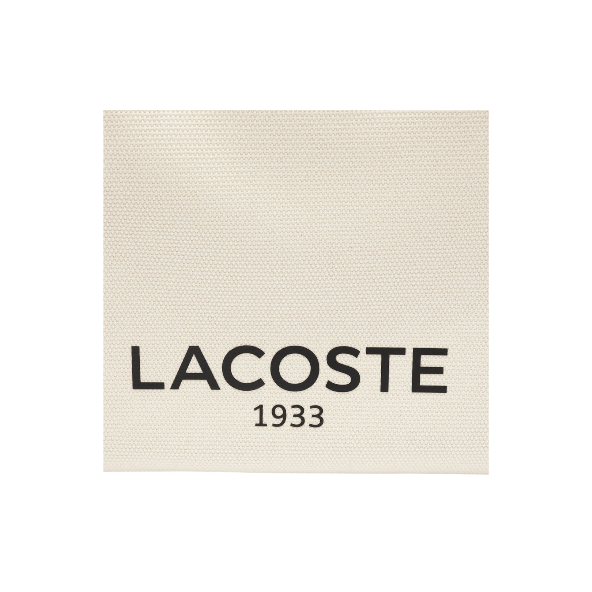 Détail logo Lacoste sur toile coton natural tan du sac Héritage Canvas